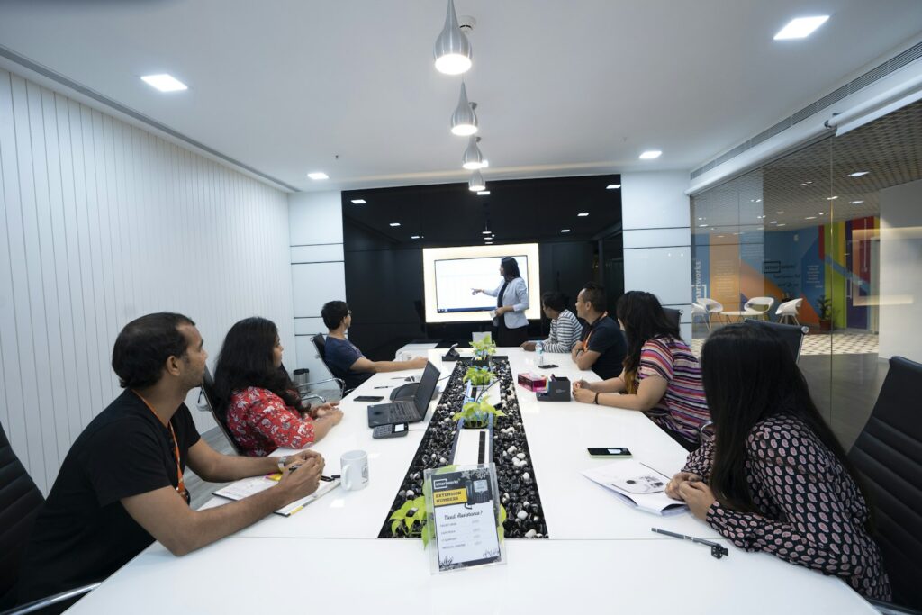 Trainer presenting to employees seated at a conference table