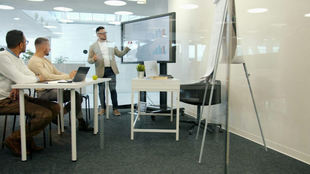 Consultant presenting results to client colleagues in a boardroom