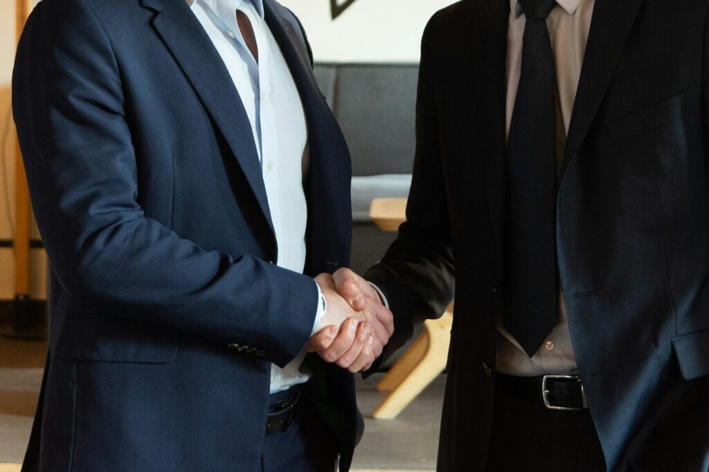 Business partners shaking hands to confirm a recruitment partnership